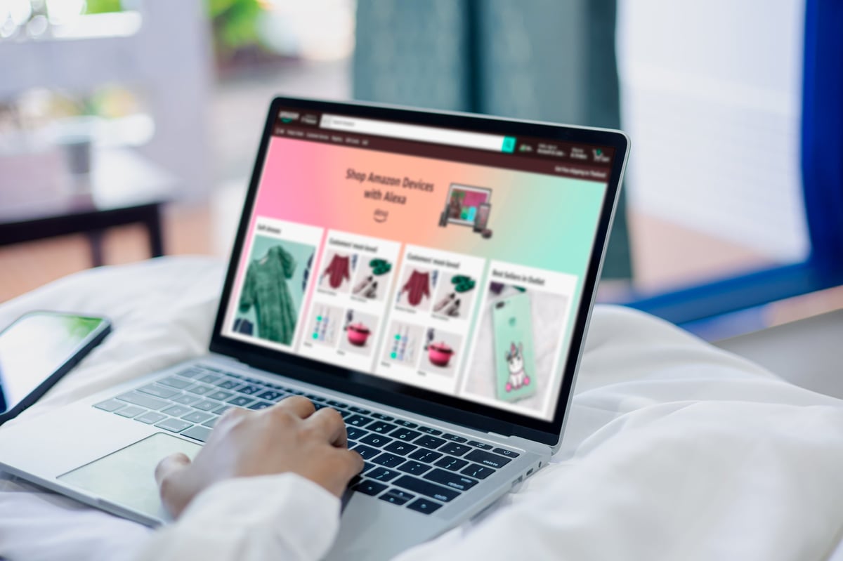 Woman browsing an online shopping website on a laptop while relaxing at home